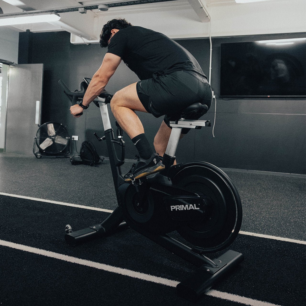 PSEB0098-Performance-Rear-Wheel-Indoor-Cycle-Indoor-Bikes-Lifestyle-Athlete-Shot_f7be77c3-2666-4c61-9e7f-f769de3e427c